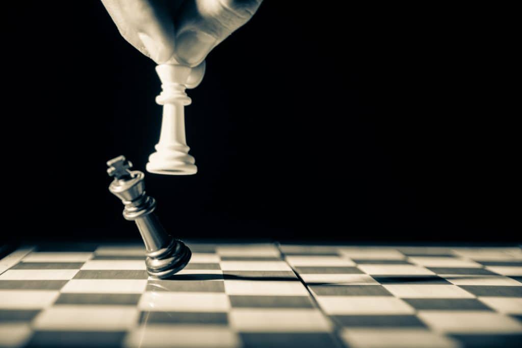 Person moving a piece in chess